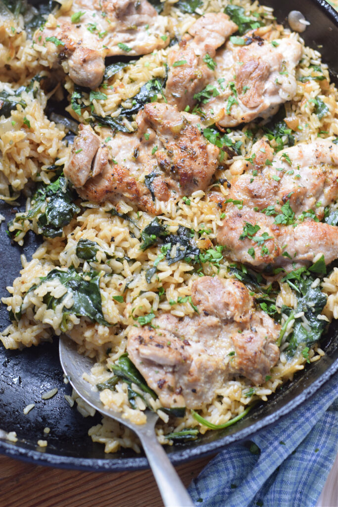 Close up of chicken and rice in a skillet.