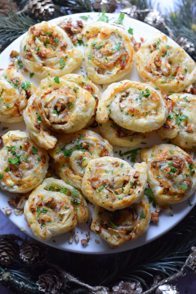 Goat cheese puff pastry appetizers on a serving plate.