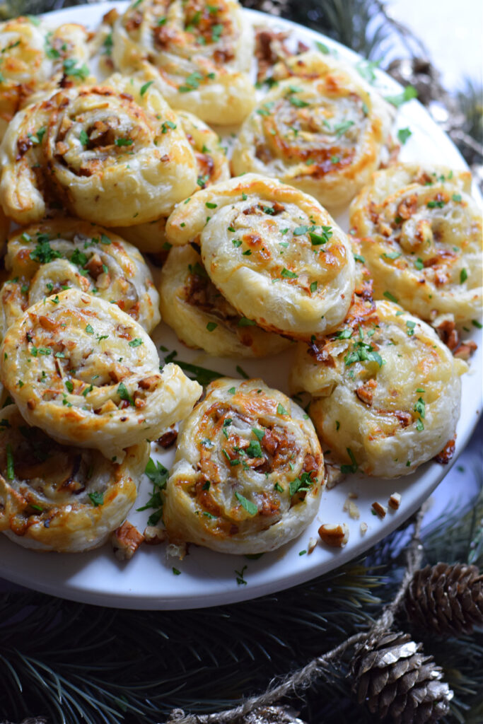 Close up of pecan and goat cheese appetizers on a plate.