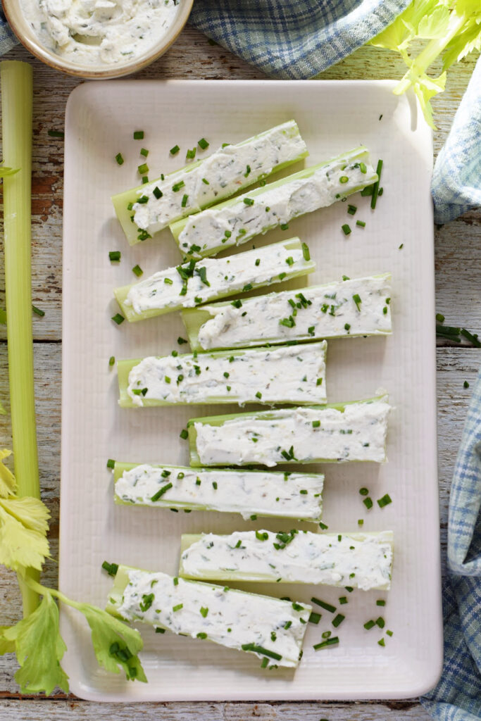 Stuffed celery on a white plate.