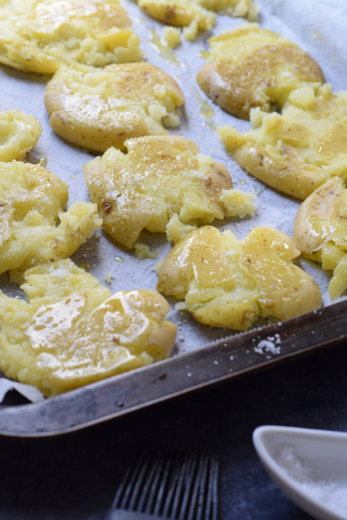 Close up the smashed potatoes on a tray.