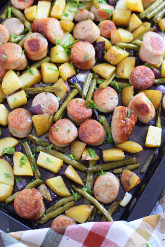 Sausage sheet pan dinner on a baking tray.