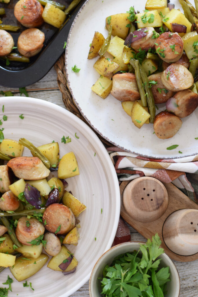 Sausages and potatoes on serving plates.