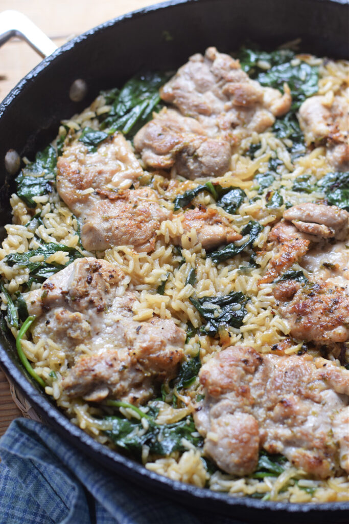 Chicken and rice in a skillet.