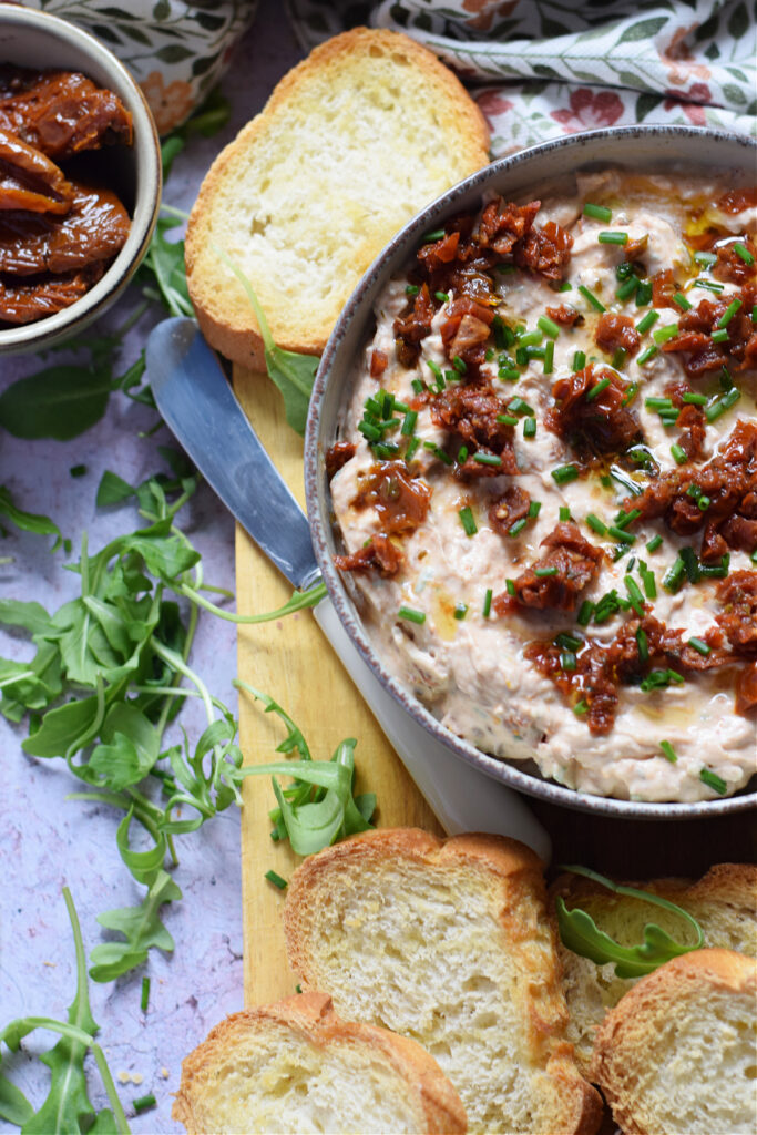 Mascarpone cheese and sun dried tomato dip in a bowl.