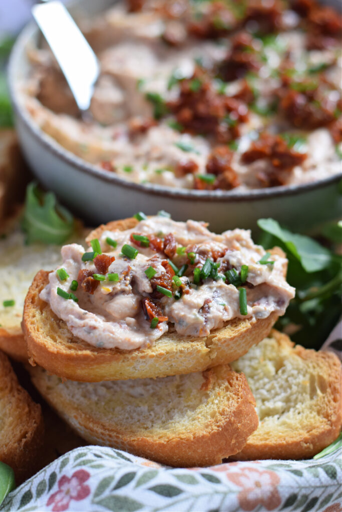 Sun dried tomato dip on baguette bread.