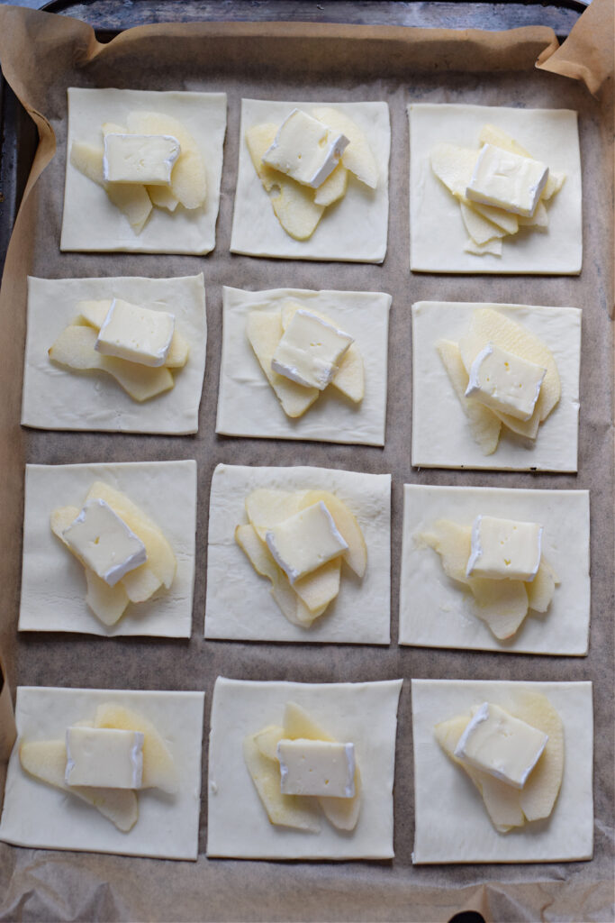 Pastry squares topped with apple and brie cheese.