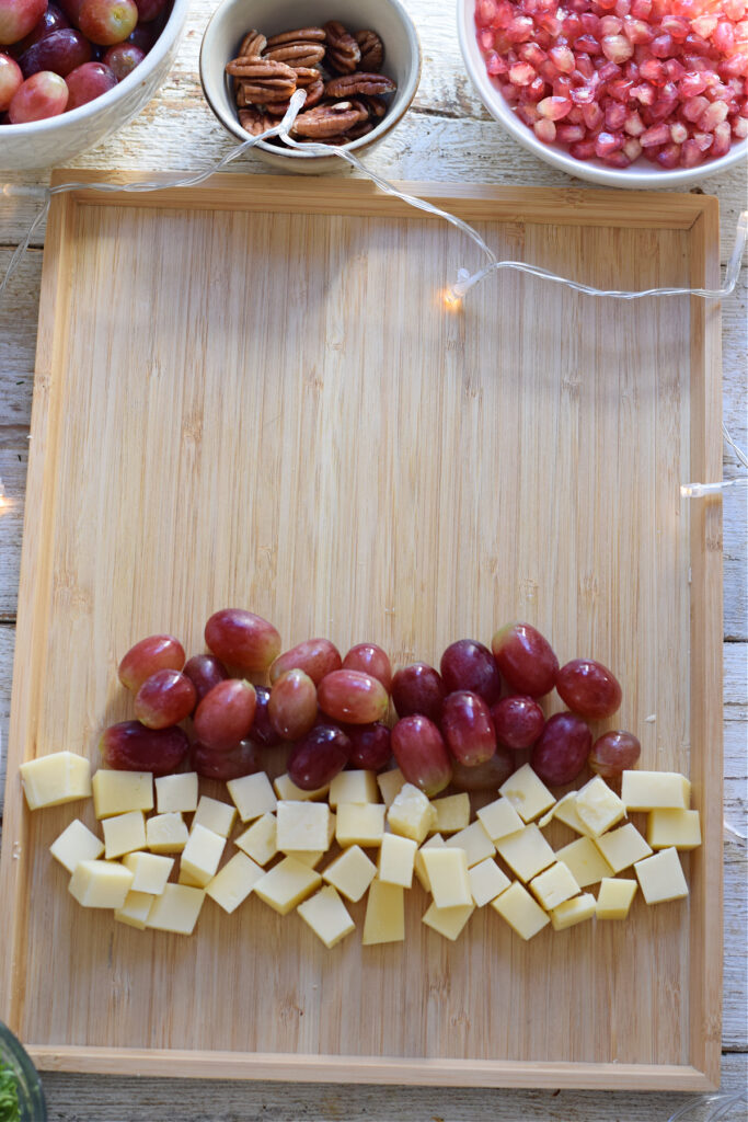 Making a fruit and cheese Christmas brunch board.