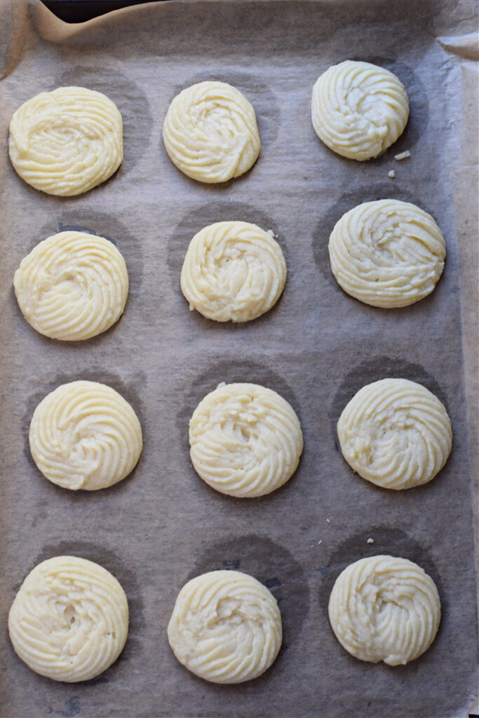 Baked shortbread cookies on a baking sheet.