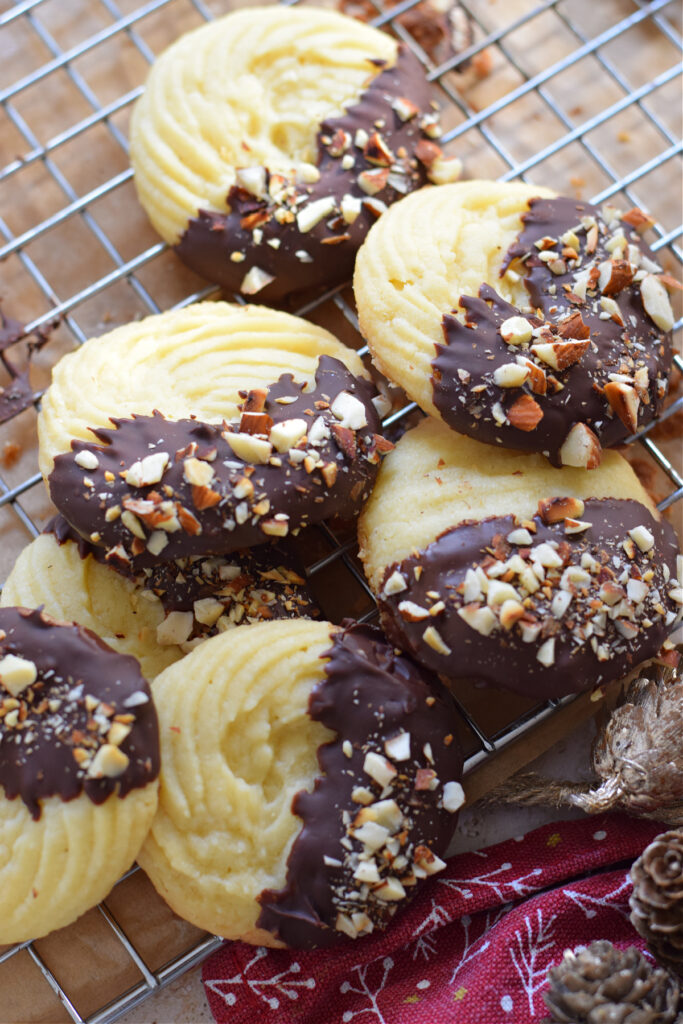 Chocolate dipped shortbread cookies on a wire rack.