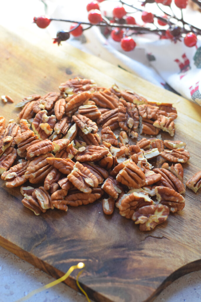 Chopped pecans on a cutting board.