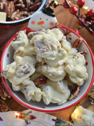 White chocolate pecan clusters in a bowl.