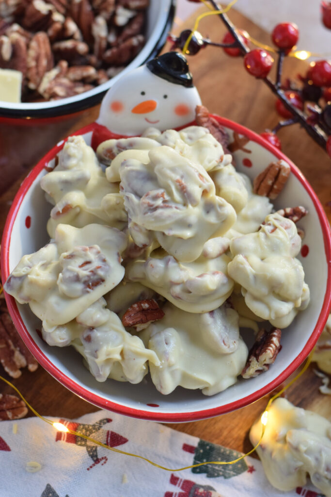 White chocolate pecan clusters in a bowl.