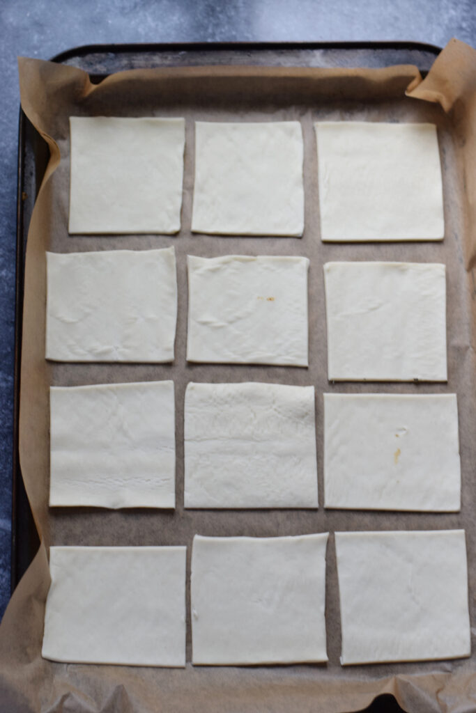 Pastry squares on a baking sheet.