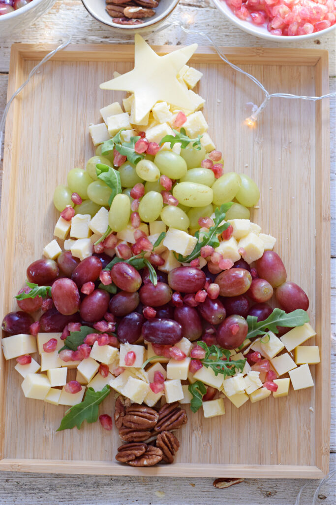 Christmas fruit and cheese board with grapes.