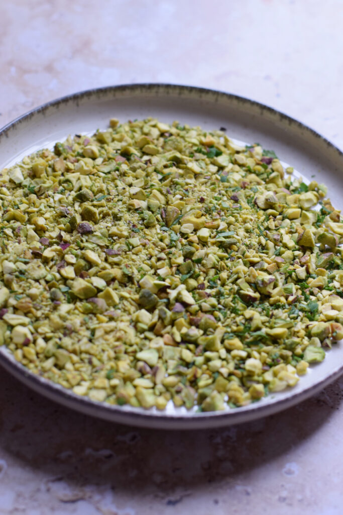 Pistachios and parsley on a plate.