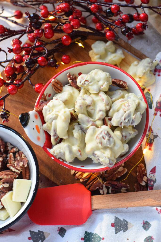 White chocolate pecan cookies in a red bowl.