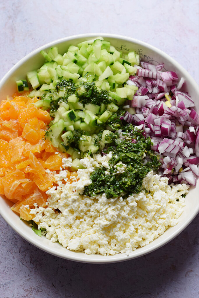 Adding a vinaigrette to a salad.