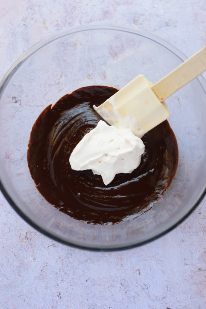 Whipped cream added to chocolate ganache.