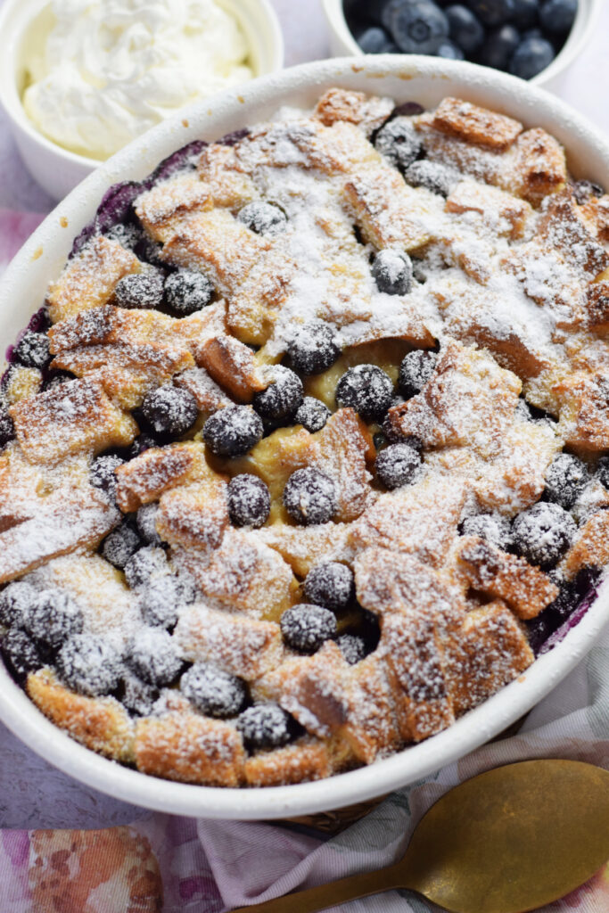 Blueberry bread pudding in a white dish.