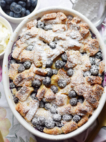 Blueberry pudding in a white casserole dish.