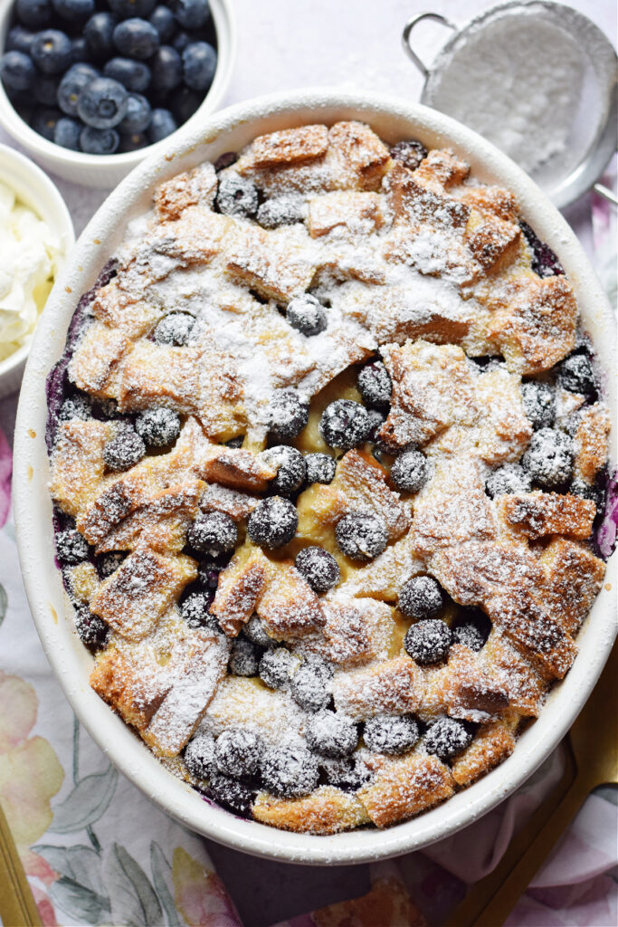 Blueberry pudding in a white casserole dish.