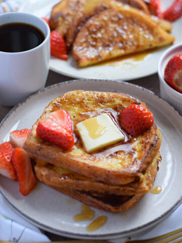 French toast with berries, maple syrup and butter.