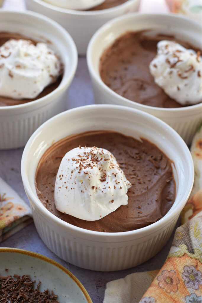 Chocolate mousse in white dessert dishes.