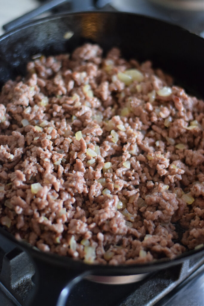 Cooked ground beef in a skillet.