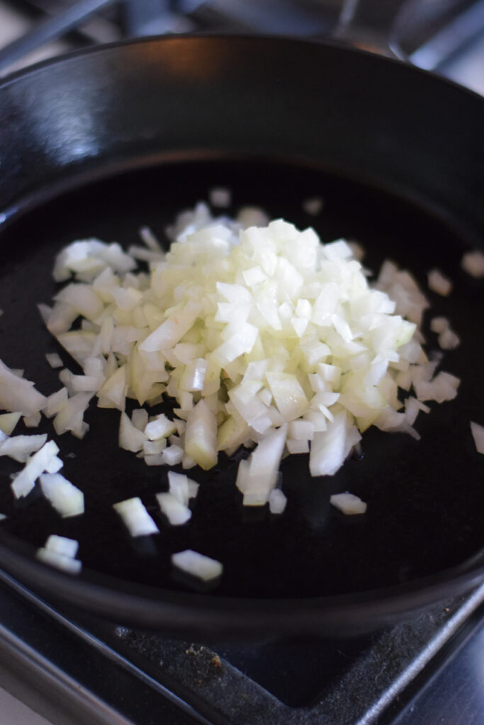 Cooking onion in a cast iron skillet.