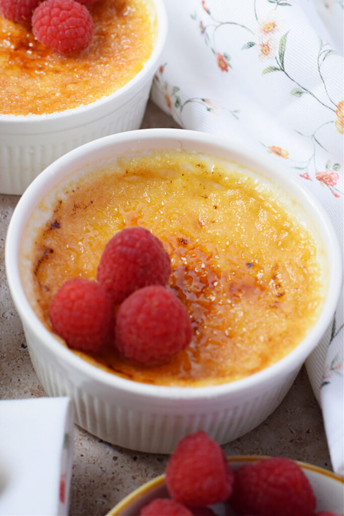 Close up of creme brulee in a white dish.