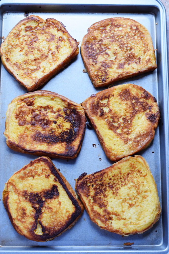 French toast slices on a baking sheet.