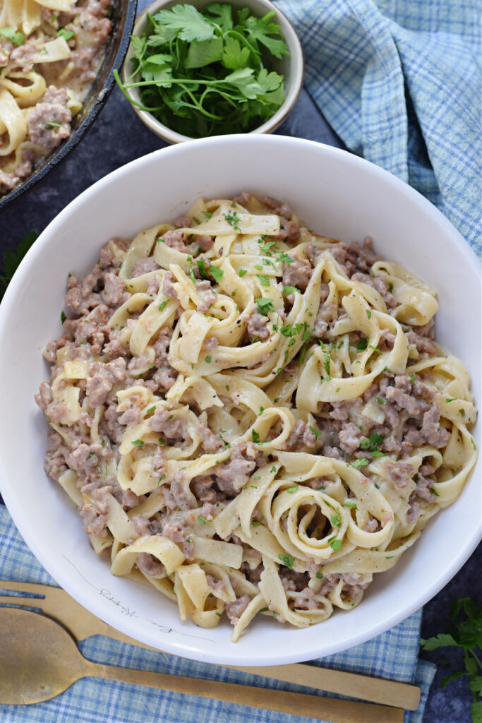 Ground beef and noodles in a skillet.