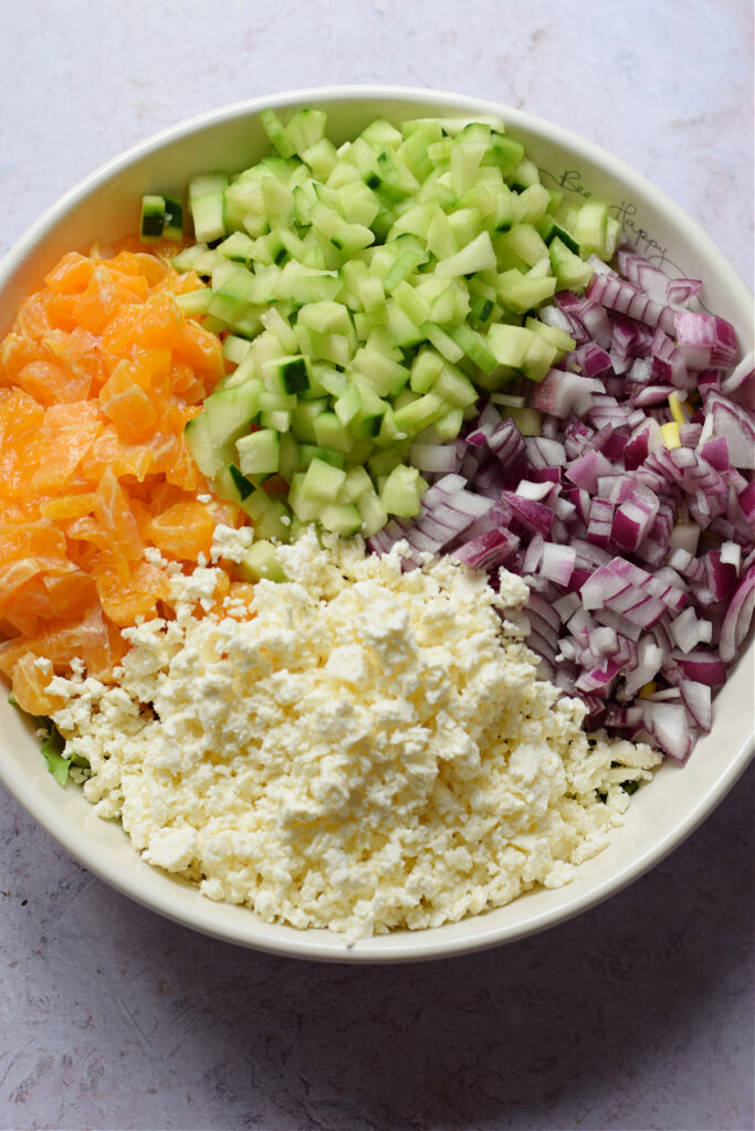 Salad ingredients in a white salad bowl.