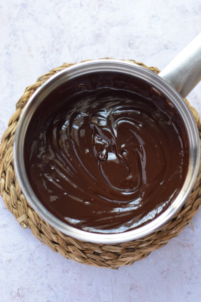 Chocolate ganache in a saucepan.