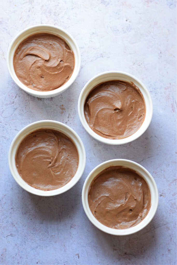 Chocolate mousse in white dessert dishes.