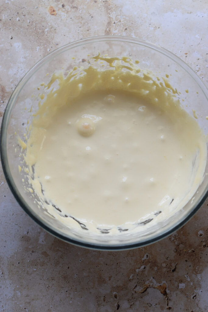 Mixed eggs and sugar in a mixing bowl.