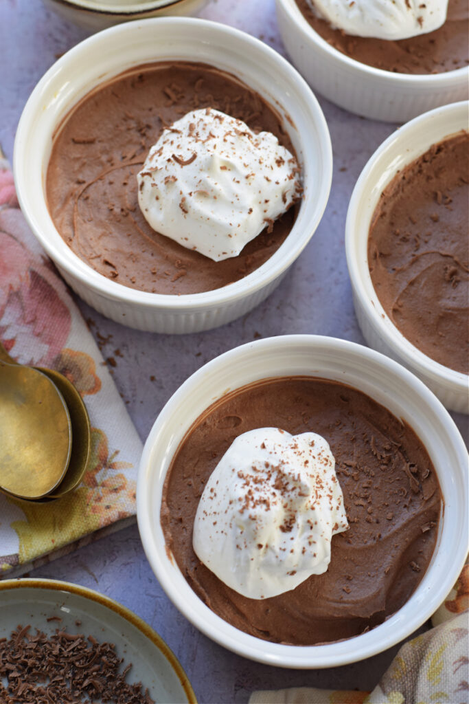 Chocolate mousse in white serving dishes.