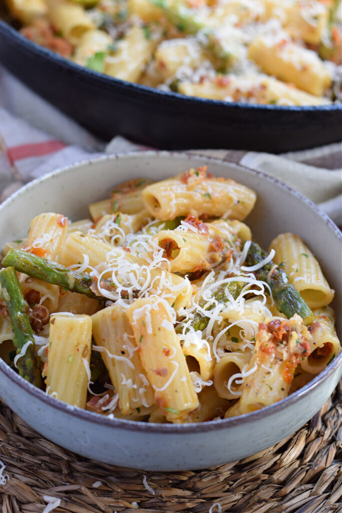 Close up of asparagus and sun dried tomato pasta.