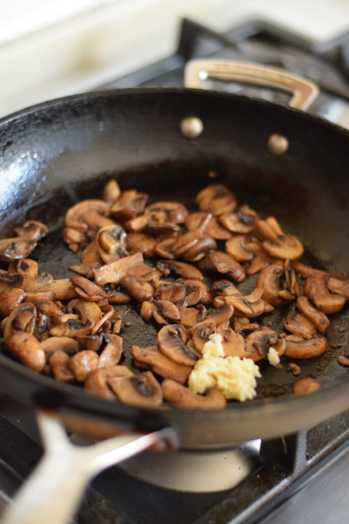 Cooked mushrooms in a skillet.