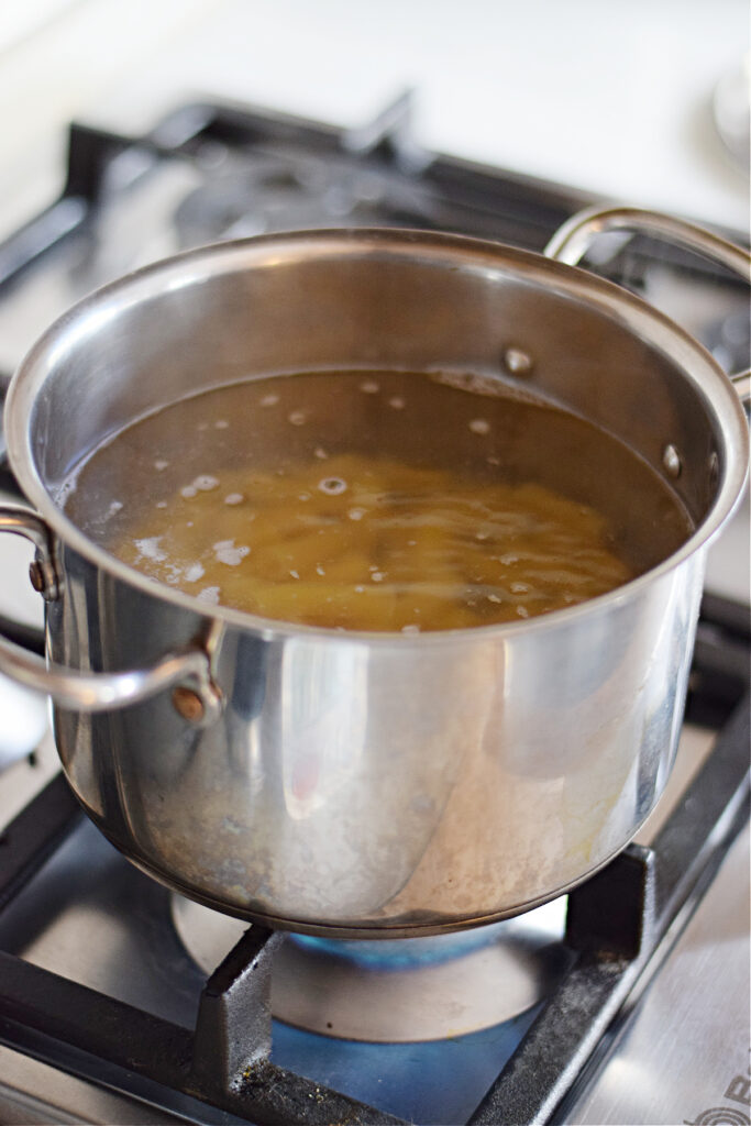 Cooking pasta in a stainless steel saucepan.