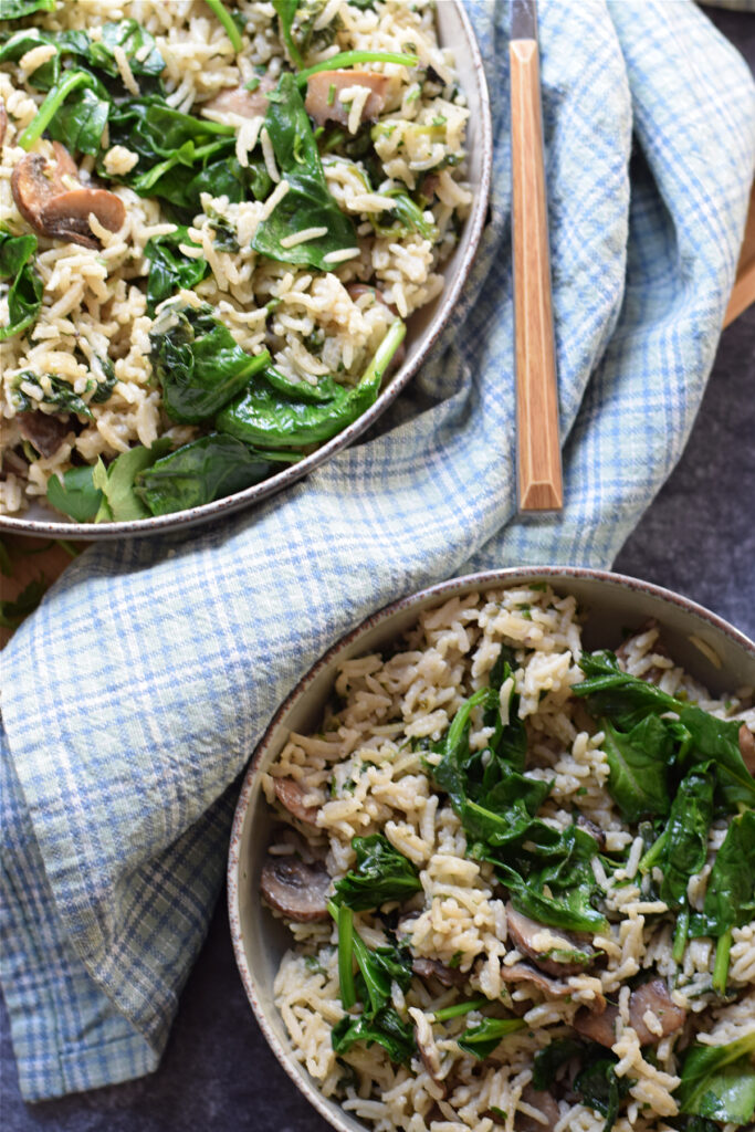 Mushroom and spinach rice in serving dishes.