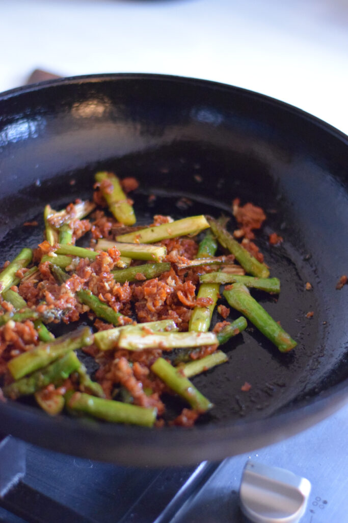 Cooking sun dried tomatoes and asparagus.