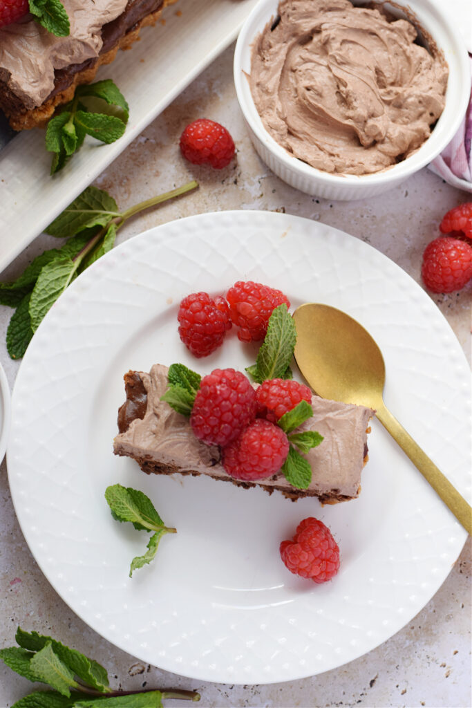 A slice of chocolate cheesecake tart on a white plate.