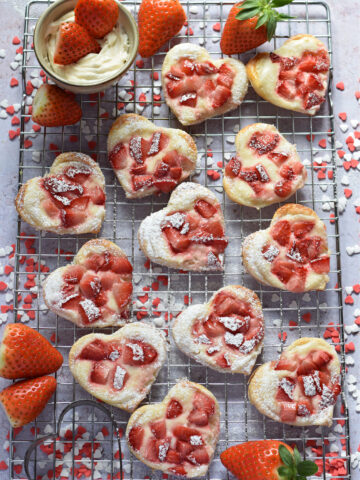 Puff pastry hearts on a baking rack.