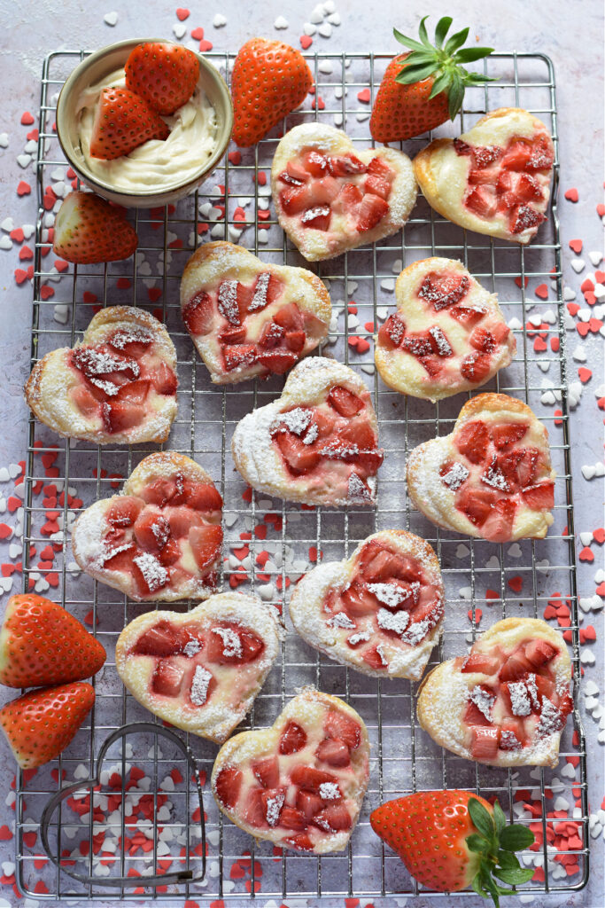 Puff pastry hearts on a baking rack.