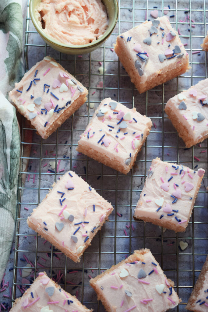 Vanilla cake squares on a baking tray.