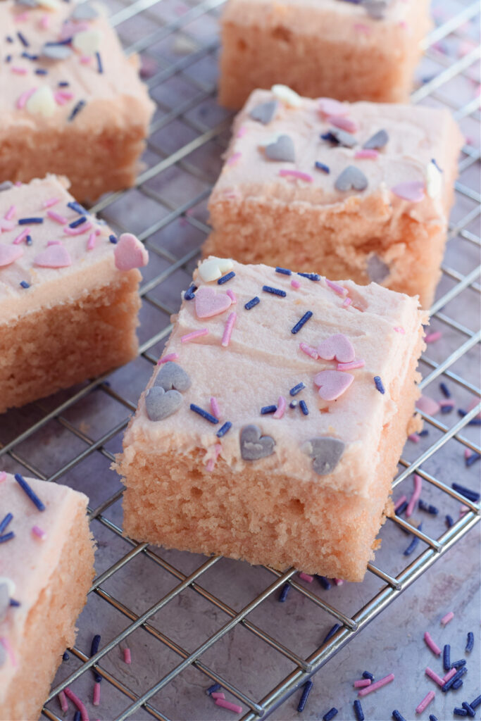 Pink cake squares with pink frosting.