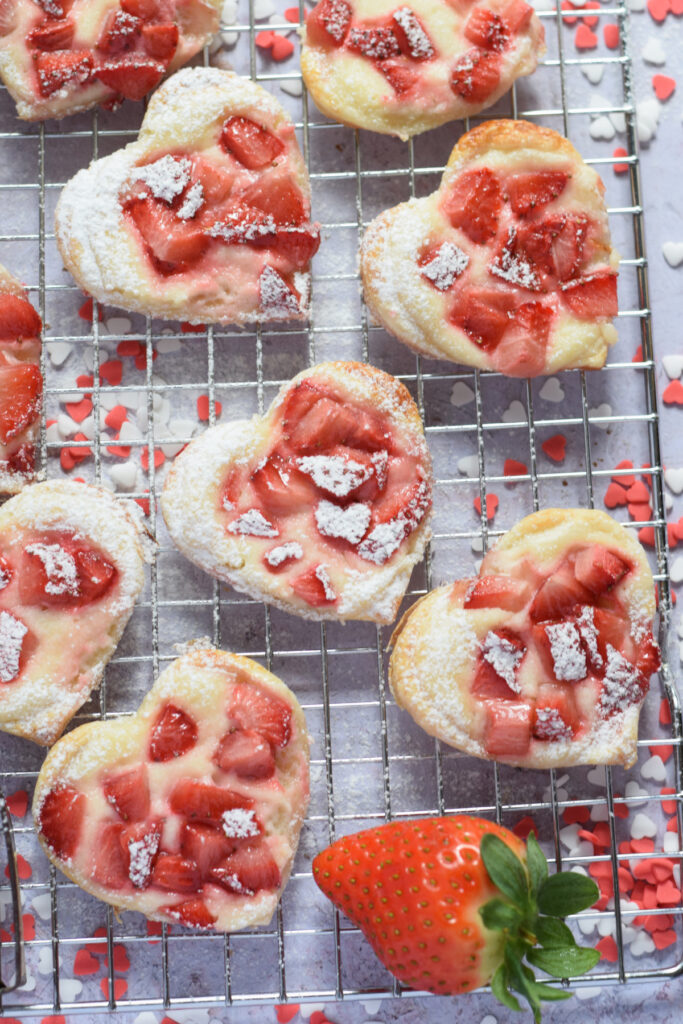 Strawberry cream cheese pastries on a baking rack.