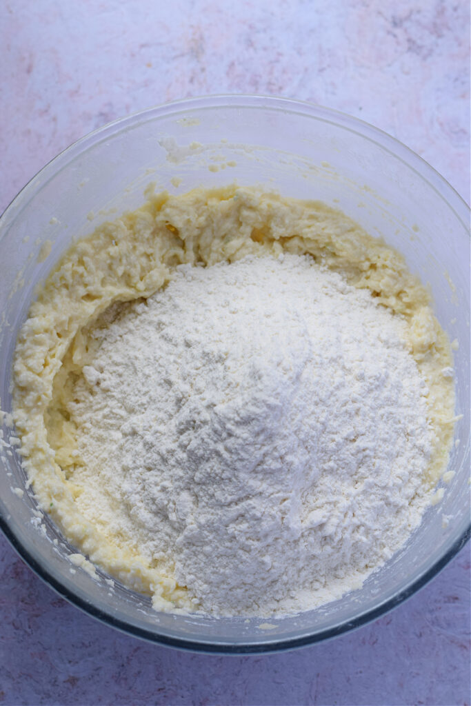 Adding flour to cookie dough.